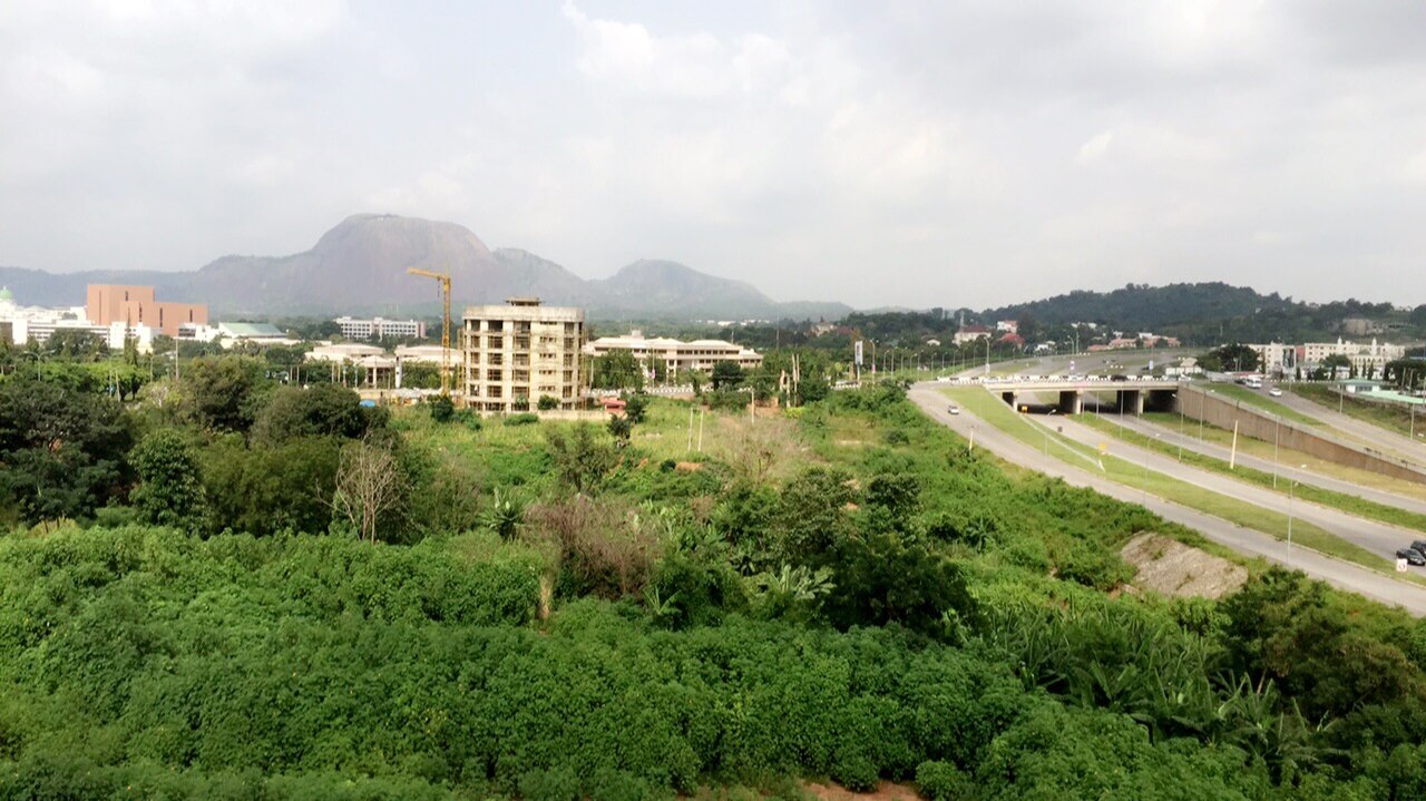 View over Abuja's Central Business District with office buildings and greenery